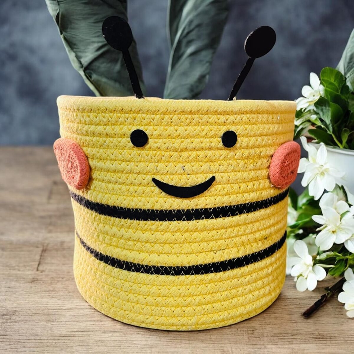 Yellow cotton rope basket with a funny face design.