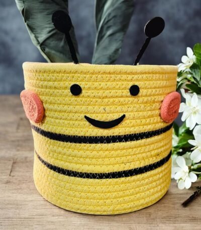 Yellow cotton rope basket with a funny face design.