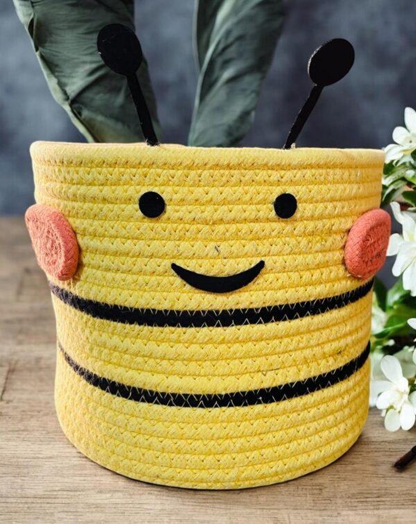 Yellow cotton rope basket with a funny face design.
